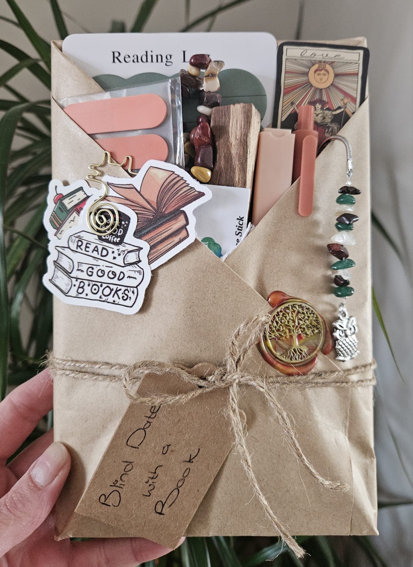 A mystery book wrapped in kraft paper and twine, with crystal gifts tucked in
